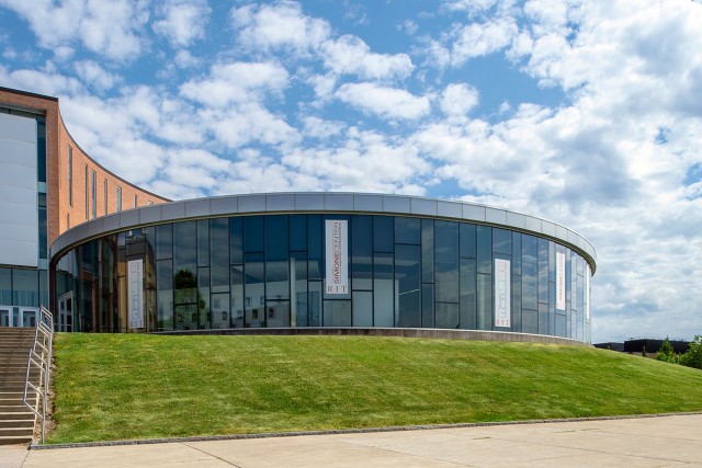 exterior of rounded, glass building.