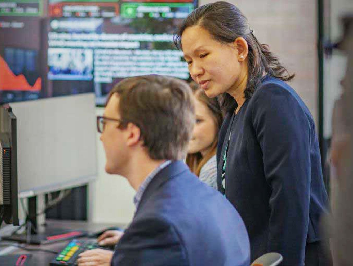 Two people looking at a computer