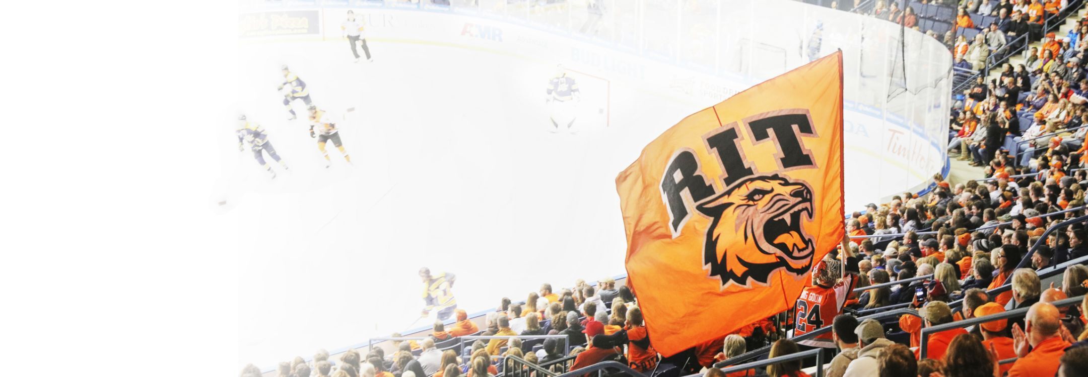 Three R I T students working on a racing cart in a workshop.