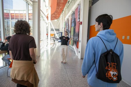 two students facing away from the camera, walking