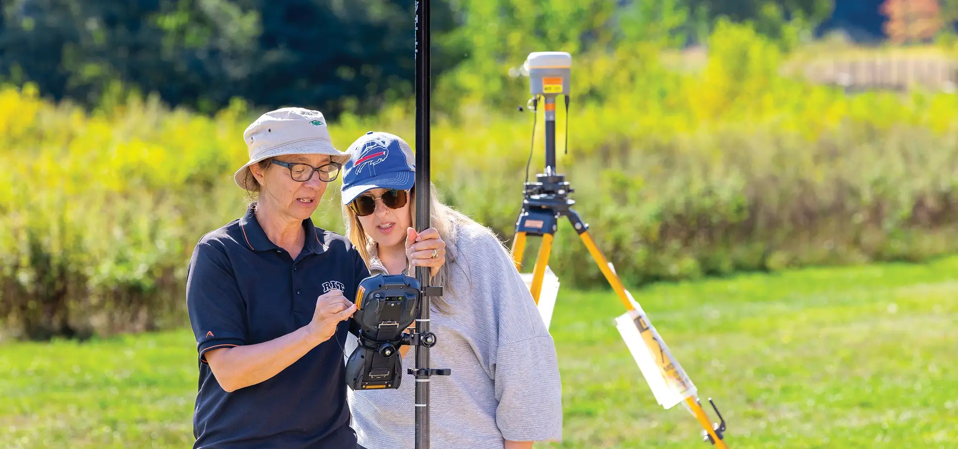 RIT researcher Nina Raqueno, left, and Amanda Ziemann, right, looking at the readings from a piece of equipment.