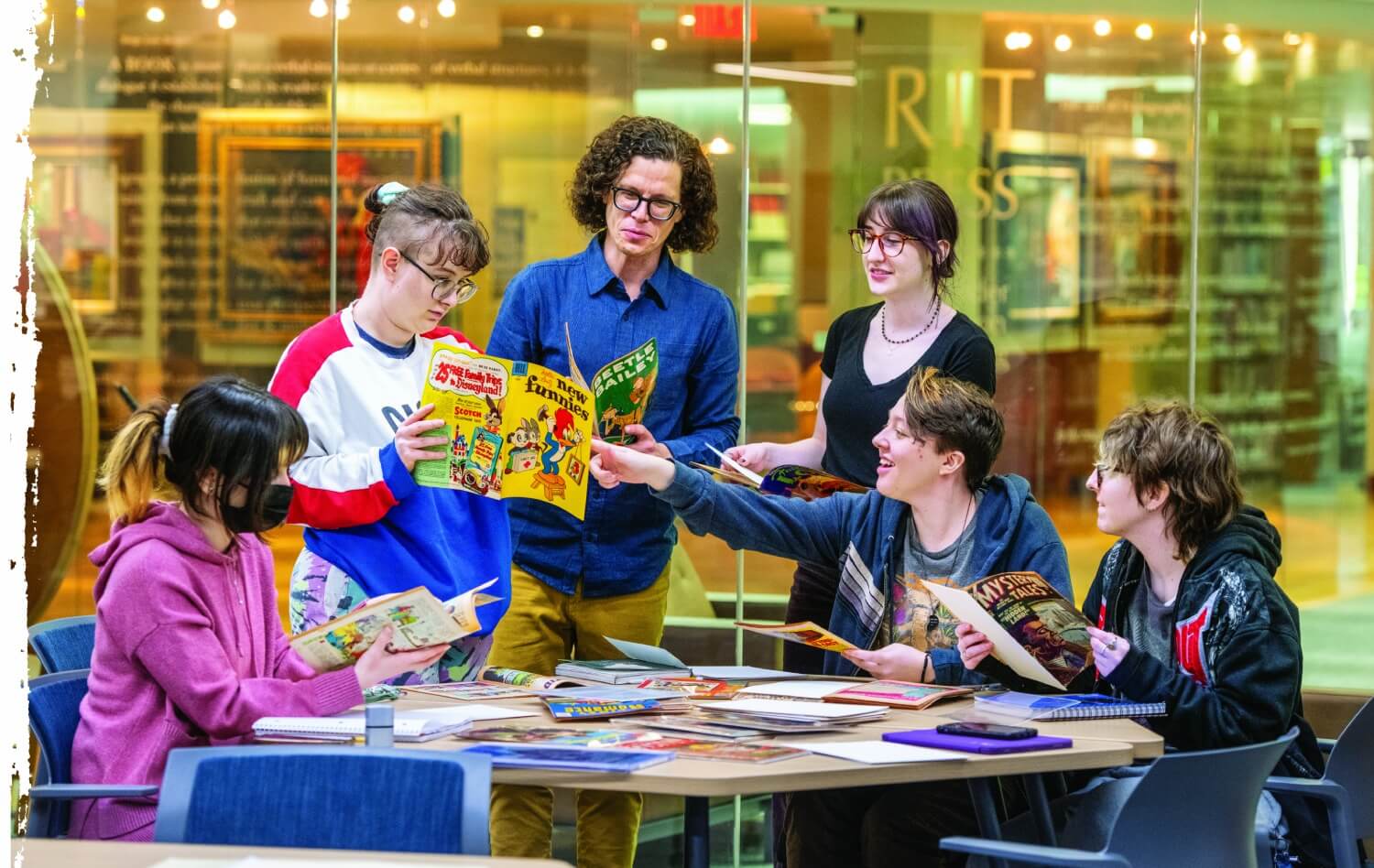 Professor daniel worden working with a group of students at a table