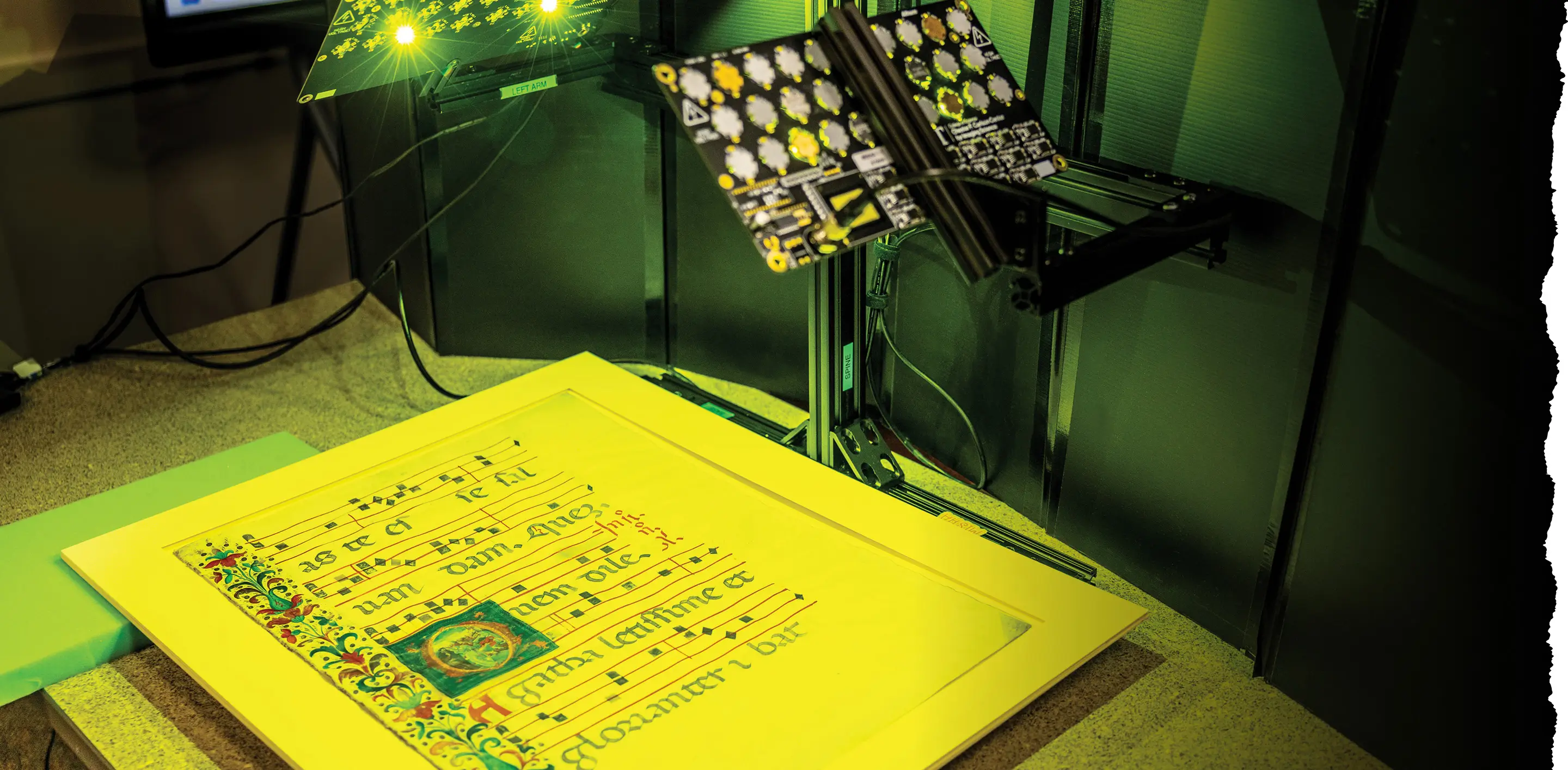 An old document sitting on a table, about to be scanned by the Multispectral Imaging System for Historic Artifacts (MISHA).