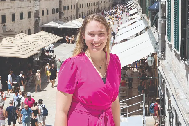 Bella Paniccia looking at the results of a scan on a laptop while red lights illuminate the document and room.