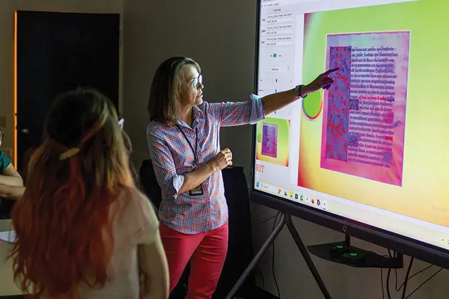 An R I T team member pointing to a screen showing the results of a MISHA scan.