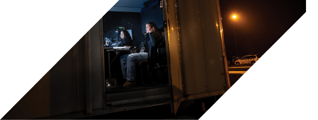 Video producers sitting in a mobile production trailer
