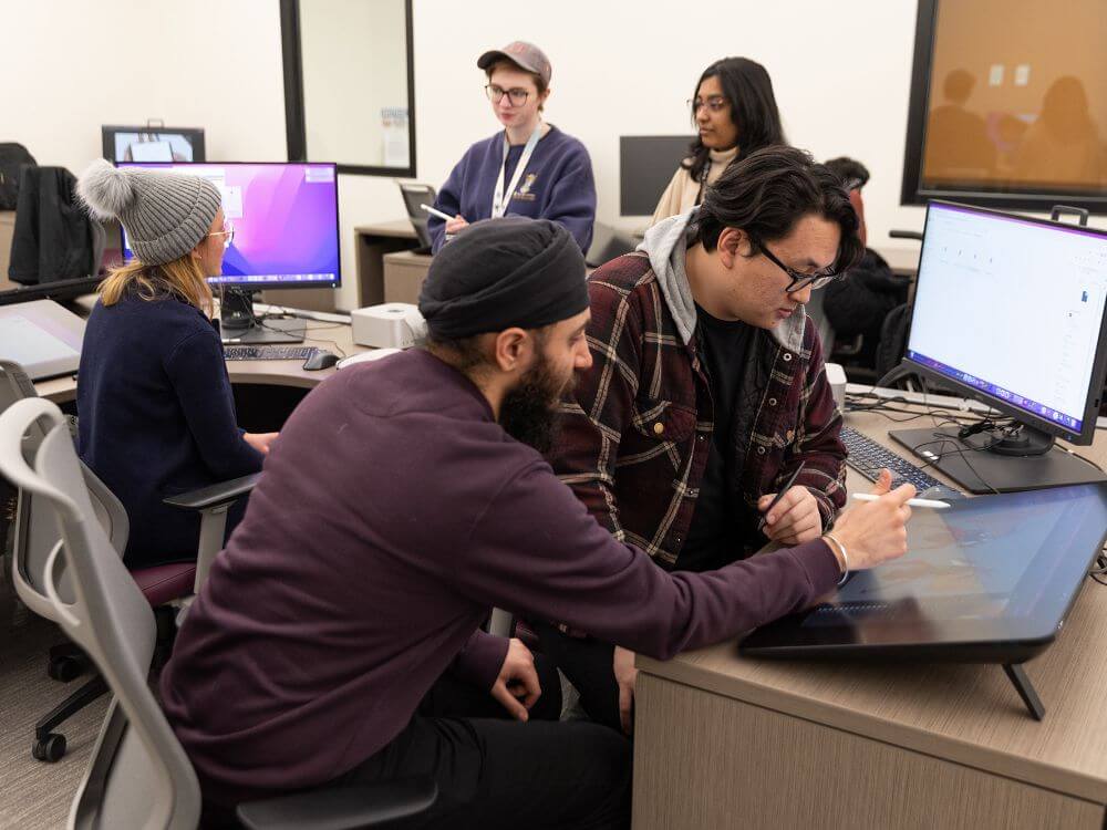 Several students working at animation workstations.