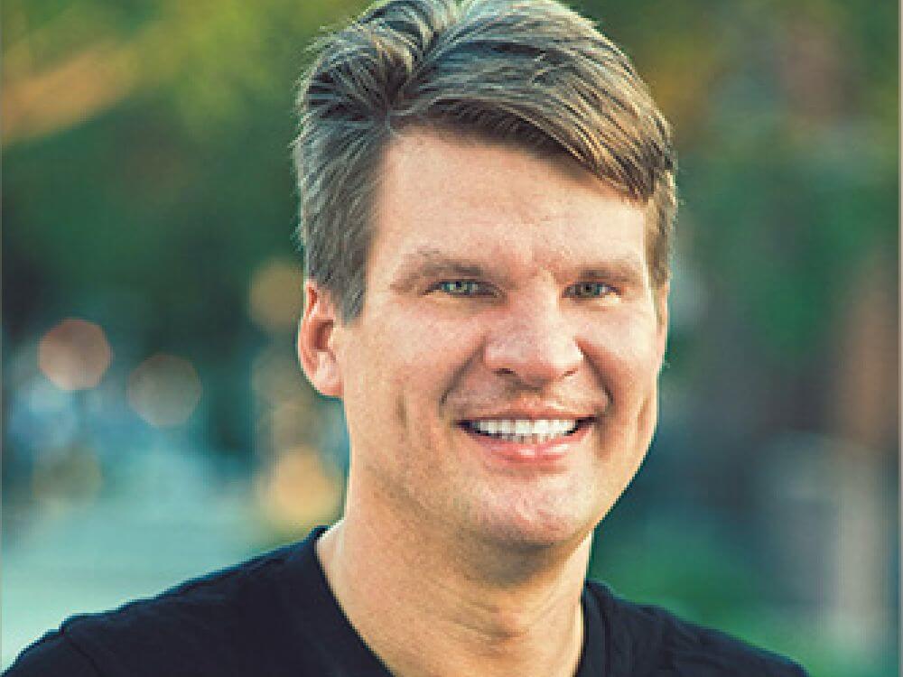 Joseph Slomka smiling into the camera.