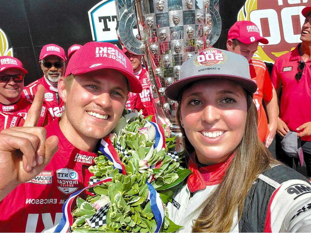 Nicole Rotondo, a trackside engineer at the 2022 Indianapolis 500, posing for a photo with winning driver Marcus Ericsson.