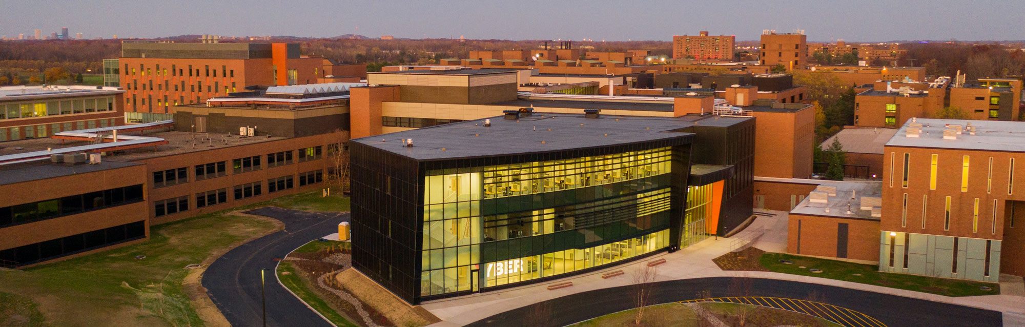 Exterior view of the Global Cybersecurity Institute at R I T around sunset..