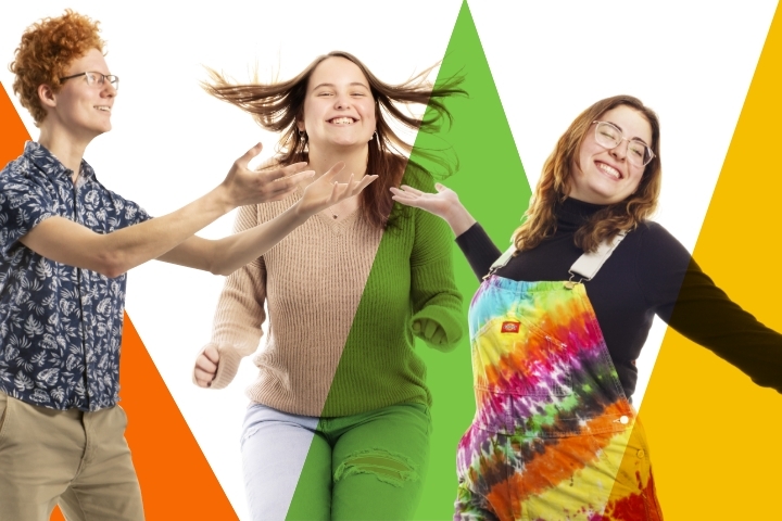 three people celebrating or dancing with many bright colors