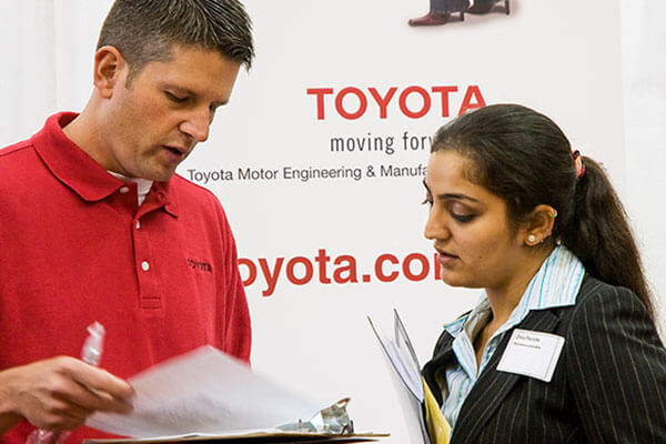 Student speaking with a representative from Toyota