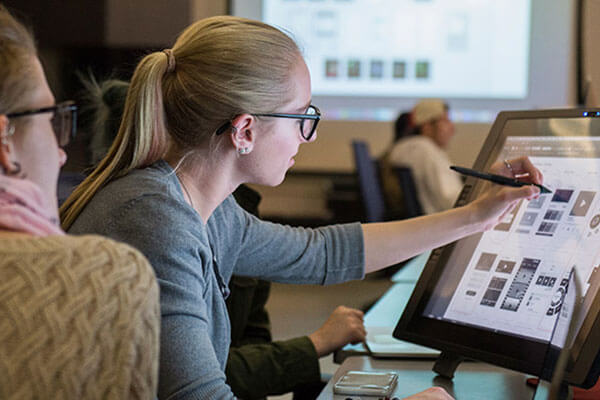 Student drawing on a monitor with a digital pen