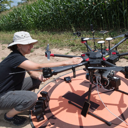 A researcher working on a drone they are about to use.