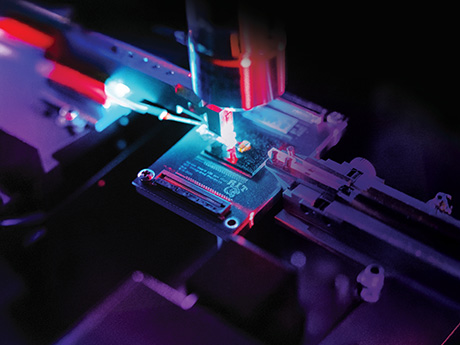 Up close shot of a microchip and a powerful microscope.