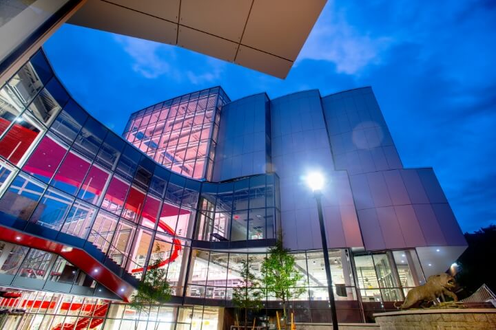 Glass building with a twilight sky background.