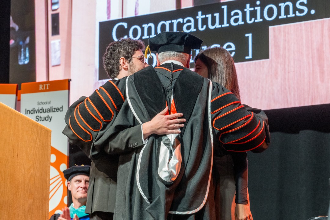 President Sanders embraces his son and daughter on stage during the ceremony.