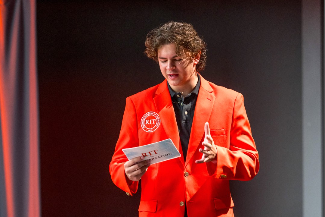 R I T student government president reads his notes while speaking.