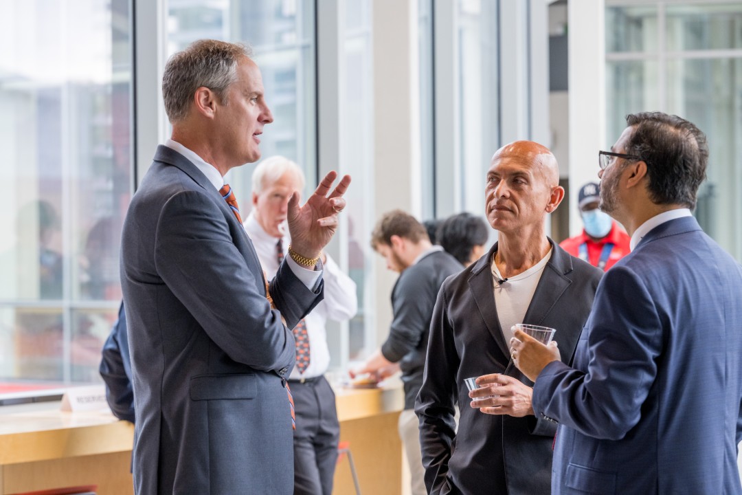 A group of people chats informally at a reception event.