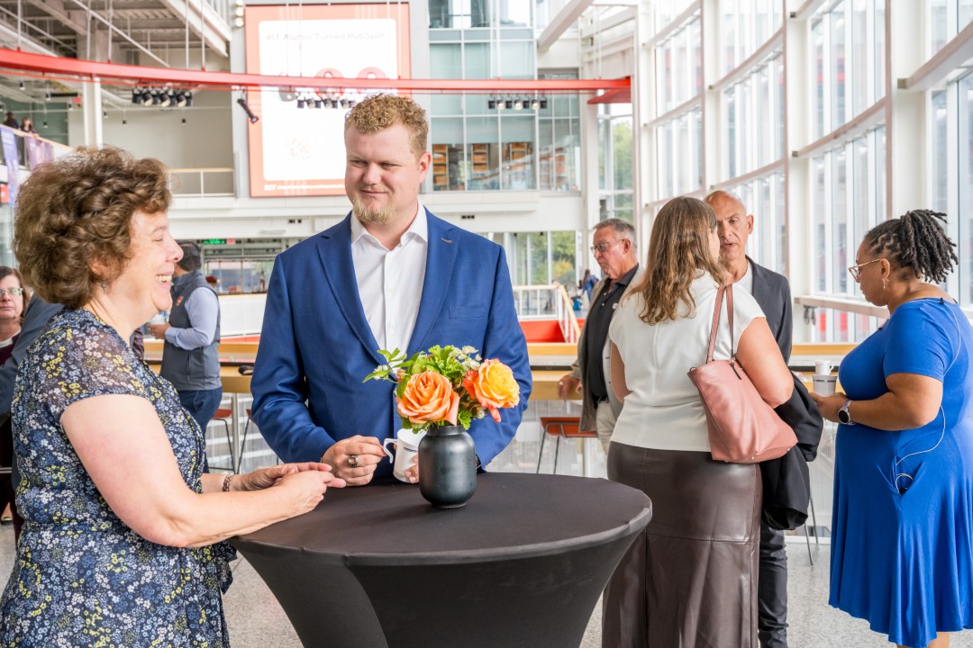 People standing and talking at a reception event.