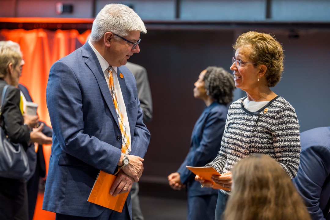 R I T president Sanders talks to Trustees Chair Susan Puglia.