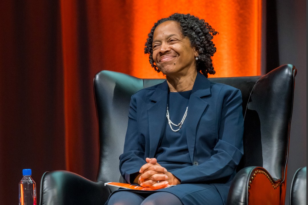 A seated woman who is smiling.