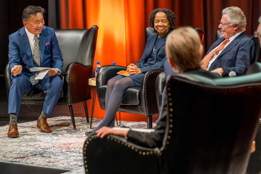 A side view of the panelists, smiling and laughing.