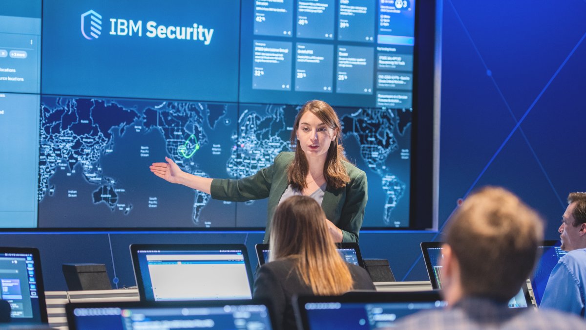 Allison Ritter giving a talk in front of a large cybersecurity panel