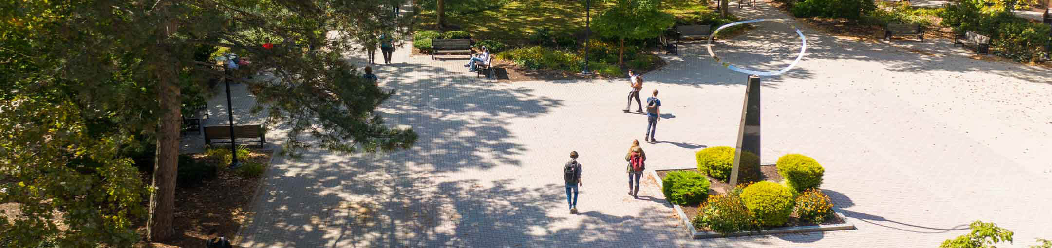 Aerial view of the R I T campus, showing students walking through Infinity Quad.