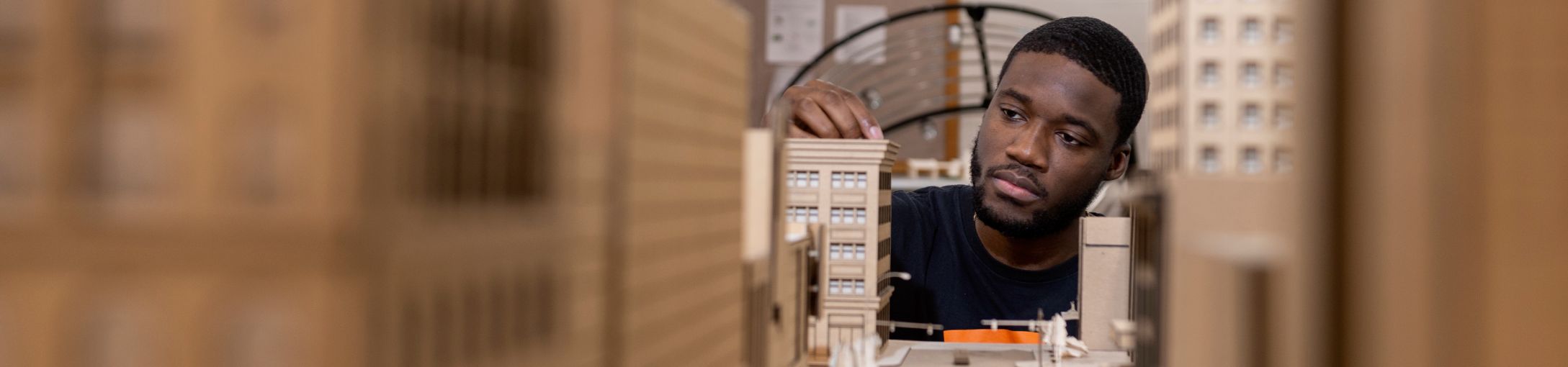 Student working on a scale model of a city