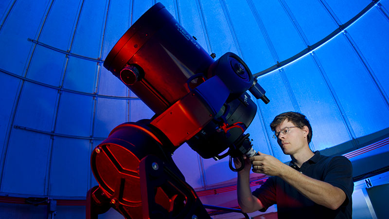 a person with a very large telescope
