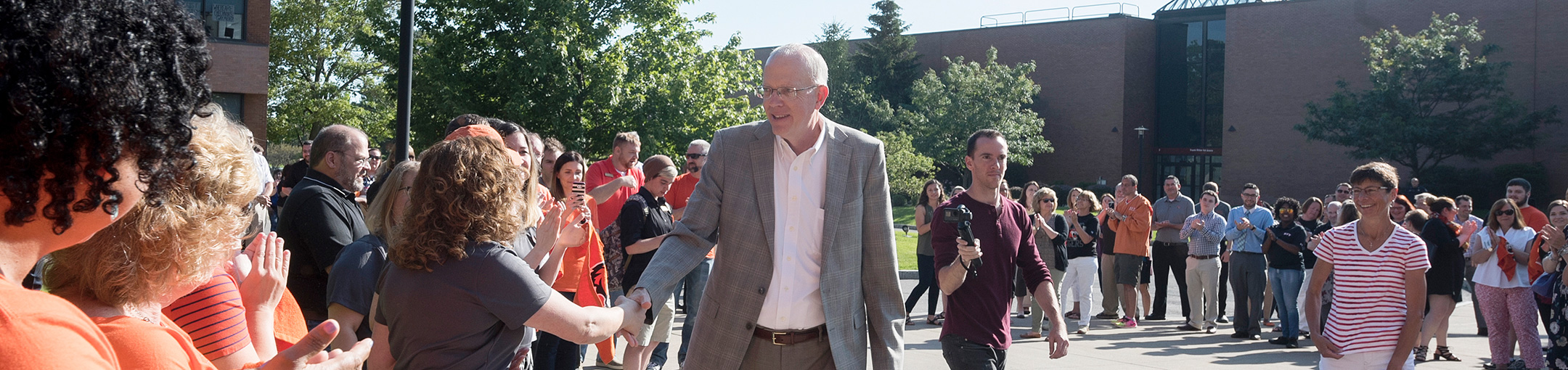 President Munson being greeted by faculty and staff