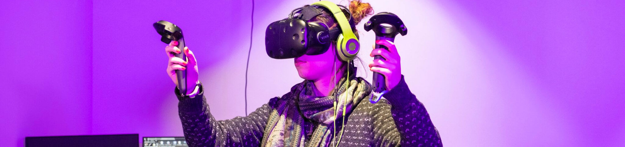 A student using an HTC Vive VR headset and controllers.