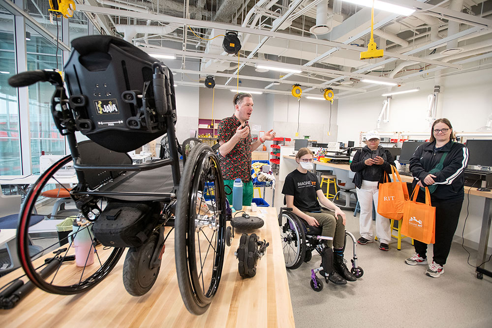 Student explains electric battery-operated wheelchair.