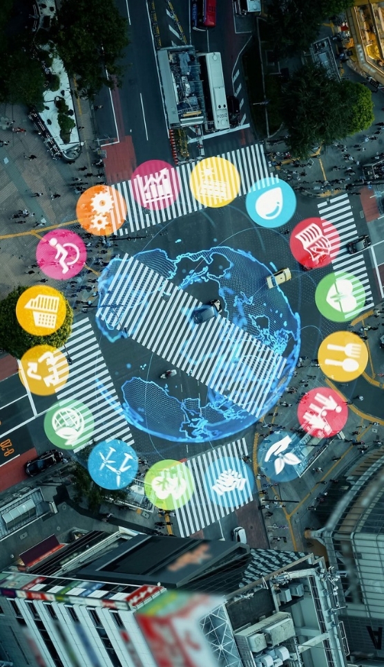 Overhead shot of a large intersection crosswalk with graphic icons overlayed in a circle