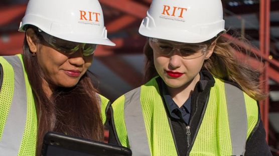Two people wearing hard hats