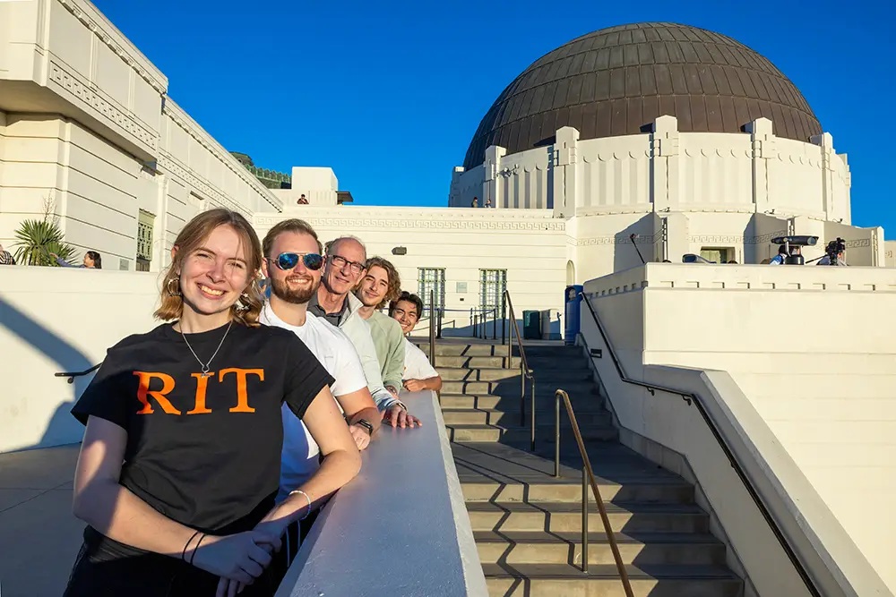 Students from the 2023 Study Away LA cohort look out over the city of Los Angeles from a balcony at the Academy Museum of Motion Pictures