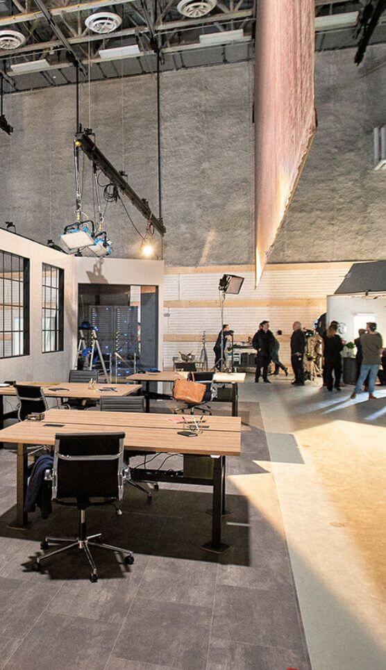 The interior of a film and animation studio, featuring several desks and work stations.