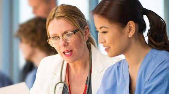 Doctor and nurse looking at a clipboard