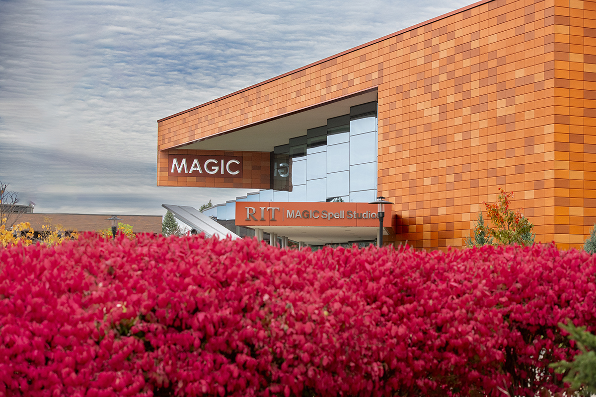 An exterior view of MAGIC Spell Studios with vibrant flowers in the foreground.