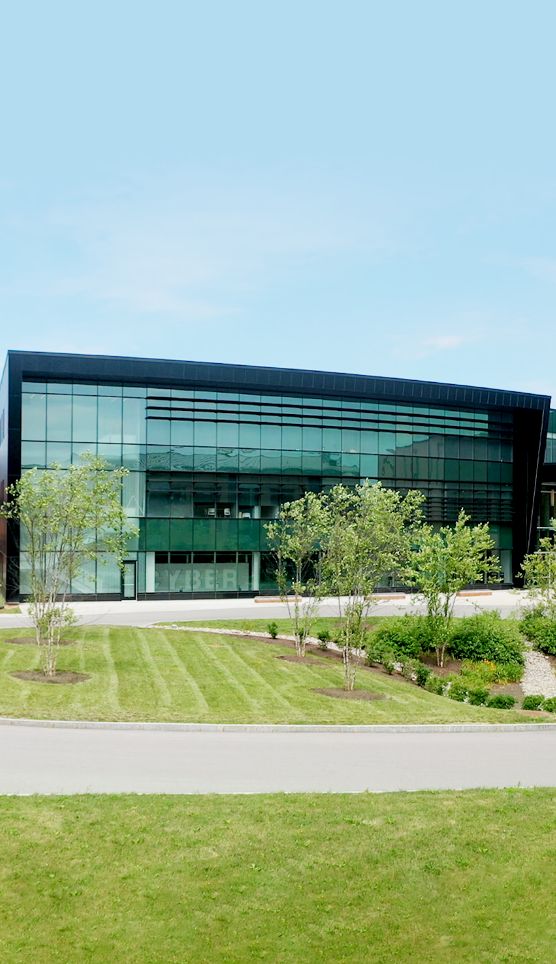 Green grass in front of a building of glass
