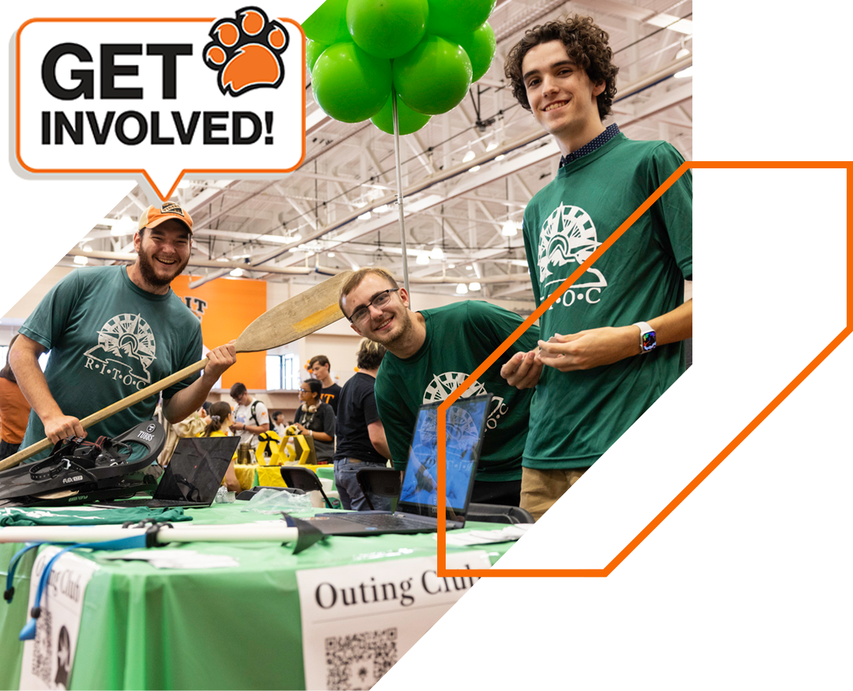 R I T students at the Tiger Activities Fair posing for a picture at their table for the Outing Club