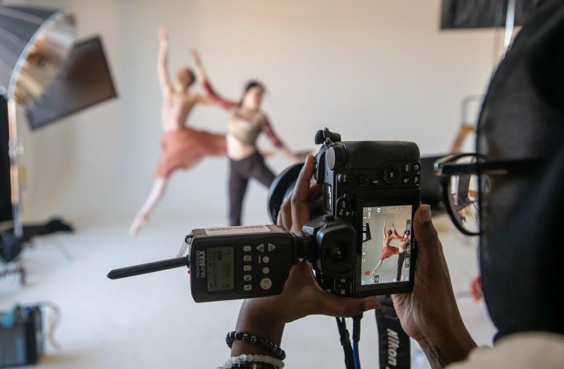 A person taking a photo of two people dancing.