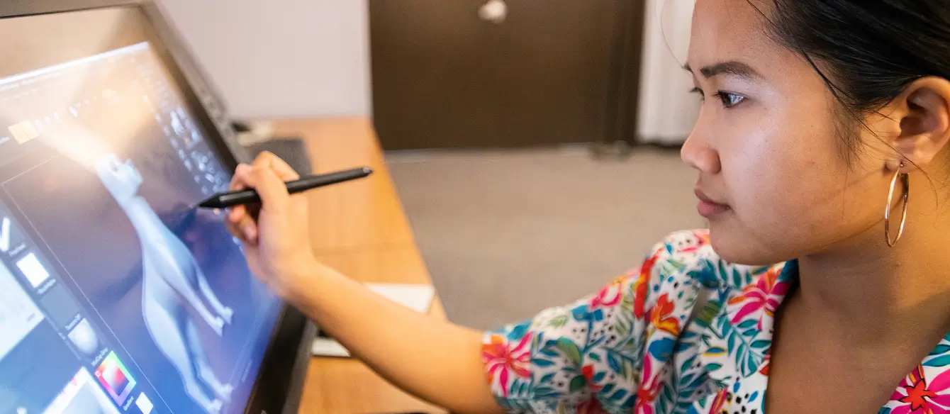 An artist drawing on a digital tablet.