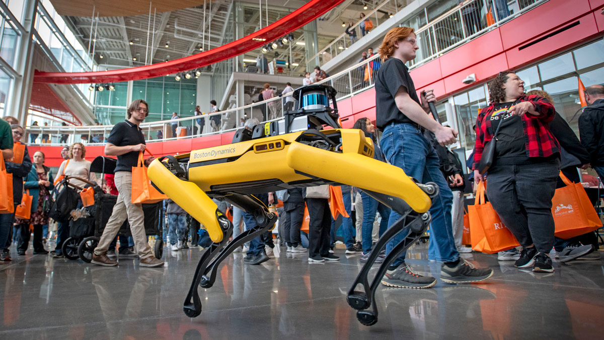 Onlookers watch a demonstration of a robot from Boston Dynamics.