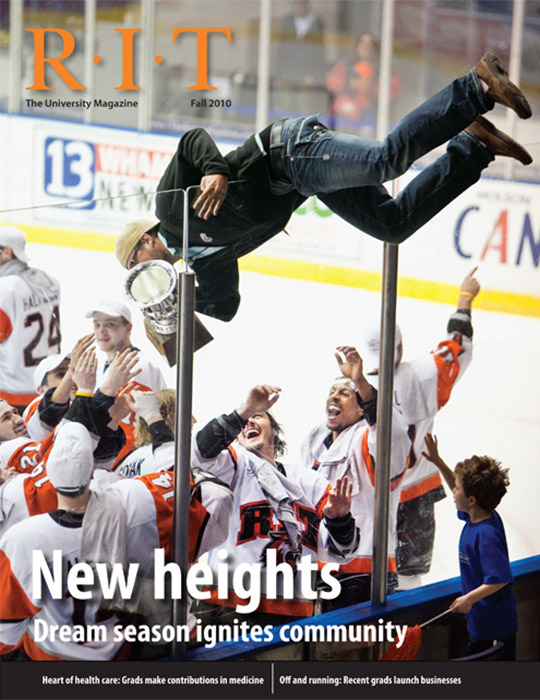 University Magazine cover featuring student in ice arena jumping over boards to touch hockey players on ice
