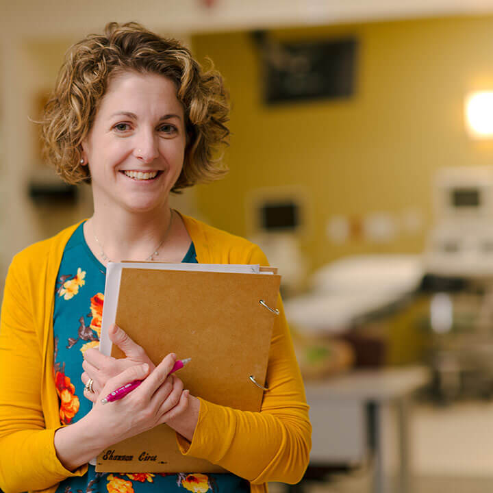 a woman holding a book.
