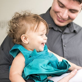 father holding a young daughter.