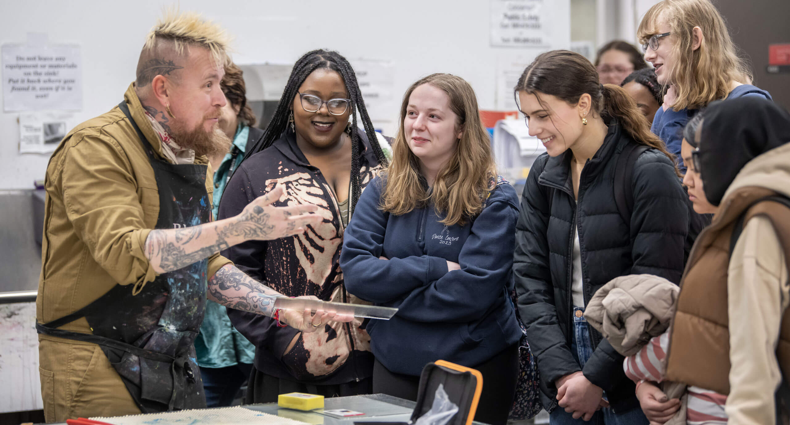 Senior lecturer and photographer, Clay Patrick McBride, showing high school students how to screen print on glass.