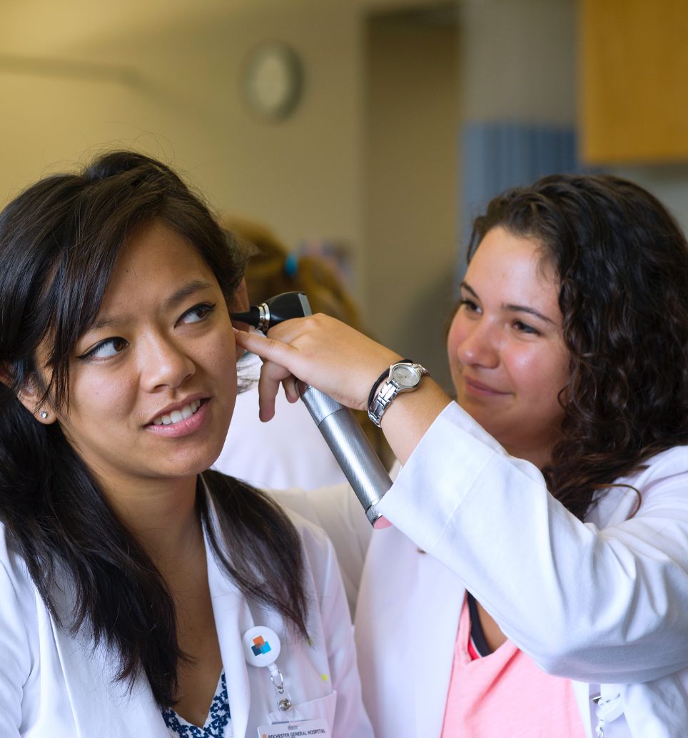 Student conducting and ear exam